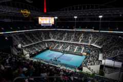 A wide shot of the Stadium Court at night with a full crowd.