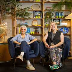 Judy Tegart Dalton sits in a chair smiling