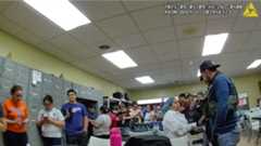 Agents inside the Nutrition Bar Confectioners factory in Cato sort people by the status in the break room.