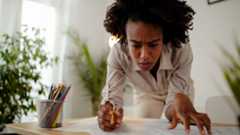 A person working at a desk with a pencil