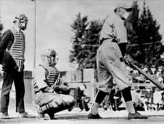 John “Beans” Reardon, left, wearing a flu mask underneath his umpire’s mask, prepares to call a pitch in a California Winter League game on January 26, 1919, in Pasadena, California. During a global influenza pandemic, all players and fans were required by city ordinance to wear facial coverings at all times while outdoors. The catcher and batter’s identities are unconfirmed, but the best available evidence suggests it might be Truck Hannah behind the plate and Rube Ellis at bat.