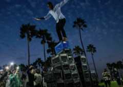 man climbing milk crate pyramid