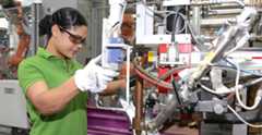 Woman working in a car manufacturing plant.