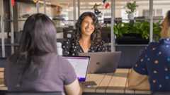 Sony Interactive employees in a meeting on their laptops in an office setting