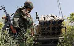 A Hezbollah fighter stands behind an empty rocket launcher, May 22, 2010. (AP/Hussein Malla) A Hezbollah fighter stands behind an empty rocket launcher, May 22, 2010. (AP/Hussein Malla)