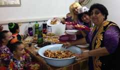 A Bukharian Jewish woman presenting her cooking at a community event in Kiryat Gat, Israel, November 3, 2014. (Courtesy of Bukharim.com/JTA)