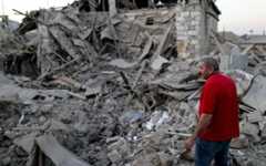 A local resident examines the ruins of a residential house destroyed in a shelling attack in the disputed Caucasus Mountains territory of Nagorno-Karabakh. (Sergei Bobylev/TASS via Getty Images)