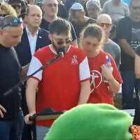 The funeral of Yaron Shai, who was killed on October 7, 2023, in the murderous Hamas attack on Israel. His brother, Ofir, in the center, is euologizing him with his father Yizhar Shai to his left, and Economy Minister Nir Barkat right behind him (Sceenshot)