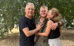 The late Shachar Friedman, center, who was killed in Gaza on November 19, 2023, and his parents, before he entered Gaza. (Facebook screen capture, used in accordance with Clause 27a of the Copyright Law)