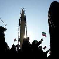 Members of the Iranian Basij paramilitary force march as a domestically built missile is displayed during a parade in Tehran, Iran, January 10, 2025. (AP/Vahid Salemi)