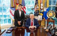 This handout photo shows US President Donald Trump, seated, posing for a photo with American-Israeli freed hostage Edan Alexander at the White House in Washington on July 3, 2025. (White House)