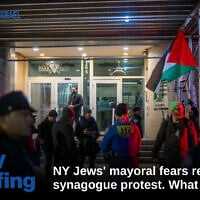 The entrance to Park East Synagogue, with dueling protesters on each side, separated by police, in New York City, November 19, 2025. (Luke Tress/Times of Israel)