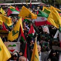Iranian demonstrators hold Iranian, Palestinian and Lebanon's Hezbollah flags in an anti-Israeli rally after their Friday prayer in Tehran, Iran, Friday, April 11, 2025. (AP Photo/Vahid Salemi)