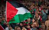 Fans wave Palestinian flags during a friendly match between a selection of Palestinian players and a group of Spanish players from the Basque Country, held to protest against Israel amid the war in Gaza, in Bilbao, Spain, November 15, 2025. (AP Photo/Miguel Oses)