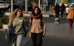 Women cross an intersection in downtown Tehran, Iran, November 20, 2025. (AP Photo/Vahid Salemi)