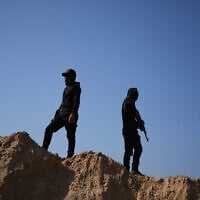 Islamic Jihad militants search for the bodies of hostages north of Nuseirat, Gaza strip, Friday, Nov. 21, 2025. (AP Photo/Abdel Kareem Hana)