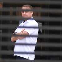 Brazil's former President Jair Bolsonaro stands at the entrance of his home where he is under house arrest in Brasilia, Brazil, Sept. 2, 2025. (AP Photo/Luis Nova, File)