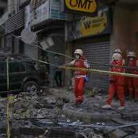 Lebanese Red Cross volunteers work at the site where an apartment building was hit during an Israeli airstrike in the southern suburb of Beirut, on November 23, 2025. (AP Photo/Bilal Hussein)