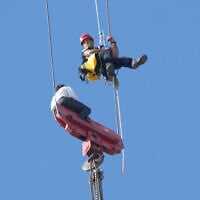 A teenager is rescued from a crane platform atop a skyscraper, where he dangled 36 stories up in the air for hours, in Jerusalem, Nov. 24, 2025. (AP Photo/Ohad Zwigenberg)