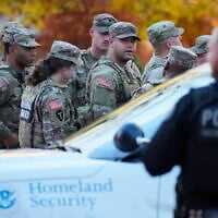 Members of the National Guard gather after reports of two National Guard soldiers were shot near the White House in Washington, November 26, 2025. (Mark Schiefelbein/AP)