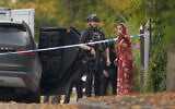 An armed police officer speaks to member of the public near the scene of terror attack at Heaton Park Hebrew Congregation synagogue, in Crumpsall, Manchester, England, on Yom Kippur, the holiest day of the Jewish year, October 2, 2025. (AP Photo/Ian Hodgson)