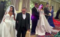 Leaked footage from mid-2024 shows Fatemeh Shamkhani in a Western-style, low-cut strapless wedding dress, left, being led down the aisle by her father Ali Shamkhani, a close adviser to Iran's Supreme Leader Ayatollah Ali Khamenei. (Screen capture: Iran International, used in accordance with Clause 27a of the Copyright Law)