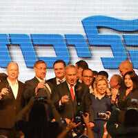 Prime Minister Benjamin Netanyahu, center, with his wife and Likud party MKs at a Likud Central Committee gathering, toast the Jewish new year in Tel Aviv, September 6, 2018. (Gili Yaari/FLASH90)
