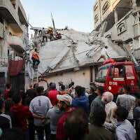 Palestinians at the site of an Israeli airstrike in Nuseirat, central Gaza, on November 22, 2025. (Ali Hassan/Flash90)