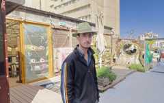 Matan Israeli, founder of the Muslala nonprofit, at the rooftop garden he manages, November 18, 2025. (Zev Stub/Times of Israel)