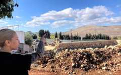 On her backyard terrace in Avivim, Limor Biton points to a hill in Lebanon and Bint Jbeil, a Hezbollah stronghold, on November 26, 2025. (Diana Bletter/Times of Israel)