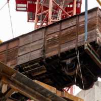 A 173-foot tower crain hoists a 20th century 12-ton railcar into the upcoming Holocaust Museum Boston. (Kenneth Berman Photography via JTA)