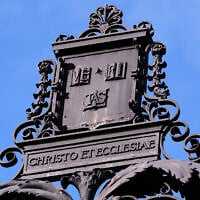 The Harvard University logo is displayed on a metal gate leading to Harvard Yard at Harvard University, September 30, 2025, in Cambridge, Massachusetts. (AP Photo/Charles Krupa)
