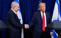 US President Donald Trump (R) shakes hands with Prime Minister Benjamin Netanyahu as Trump listens to a question from a reporter at the end of a news conference at Mar-a-Lago, on December 29, 2025, in Palm Beach, Fla. (AP Photo/Alex Brandon)