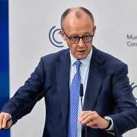 Germany's Chancellor Friedrich Merz prepares to address the audience during the Munich Security Conference in Munich, Germany, Friday, Feb. 13, 2026. (AP Photo/Michael Probst)