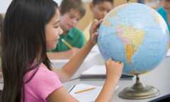 Menina apontando no globo terrestre os países da América.