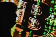 Silhouette of Donald Trump in front of a digital projection of bitcoin in Clermont-Ferrand France on 13 June 2025