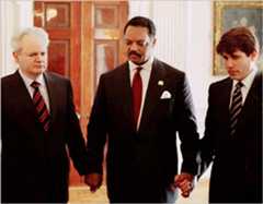 Rev. Jesse Jackson holds hands with Yugoslav President Slobodan Milosevic and U.S. Rep. Rod Blagojevich.