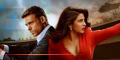 Richard Madden and Priyanka Chopra back-to-back, arms outstretched