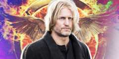 Haymitch Abernathy in front of a burning mockingjay pin in The Hunger Games.