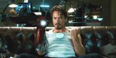 Robert Downey Jr. as Tony Stark fixing his Iron Man armor from the movie Iron Man (2008)