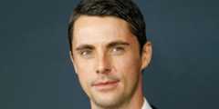 Matthew Goode against a blue background