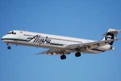 An Alaska Airlines MD-83 flying in the sky.