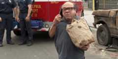Danny DeVito as Frank Reynolds standing outside Paddy's Pub with a bag of fish and chips in the It's Always Sunny in Philadelphia episode “Paddy's Has a Jumper.”