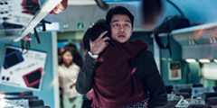 Gong Yoo runs down the train aisle while holding his daughter in Train to Busan