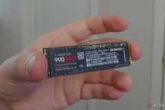 An image showing a person holding Samsung 990 Pro SSD.