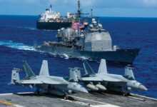 The Ticonderoga-class missile cruiser USS Chancellorsville (CG 62) and USNS 2nd Lt. John P. Bobo (T-AK 3008) steam alongside the Navy’s forward deployed aircraft carrier USS Ronald Reagan (CVN 76) during a photo exercise for Valiant Shield 2018