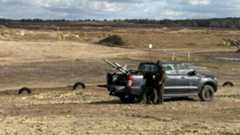 The Merops counter-drone system placed on a black truck bed with a soldier operating it.