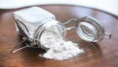Spilled baking soda from a glass jar.