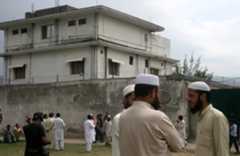 FILE - In this May 5, 2011 file photo, local residents and media are seen outside the house where al-Qaida leader Osama bin Laden was caught and killed in Abbottabad, Pakistan.  Local residents say Pakistan has started to demolish the compound in the northwest city of Abbottabad where Osama bin Laden lived for years and was killed by U.S. commandos. Two residents say the government brought in three mechanized backhoes Saturday, Feb. 25, 2012,  and began destroying the tall outer walls of the compound after sunset. They set up floodlights to carry out the work.  (AP Photo/Aqeel Ahmed, File)