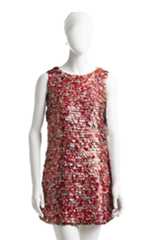 The Real Thing, Coca-Cola–can paillette dress, spring 1994. Photograph © Jason Frank Rothenberg. The Coke can makes an improbable appearance on the runway: Mizrahi used an elaborate process to create these custom paillettes from real Coca-Cola cans. He worked with the charity We Can, which employed homeless New Yorkers to collect cans to recycle; these were shipped to the sequin-maker Langlois-Martin in Paris, where they were cut into paillettes that were then sent to India to be beaded onto dresses. The result is a high-fashion, nearly weightless modern take on a ubiquitous American icon.